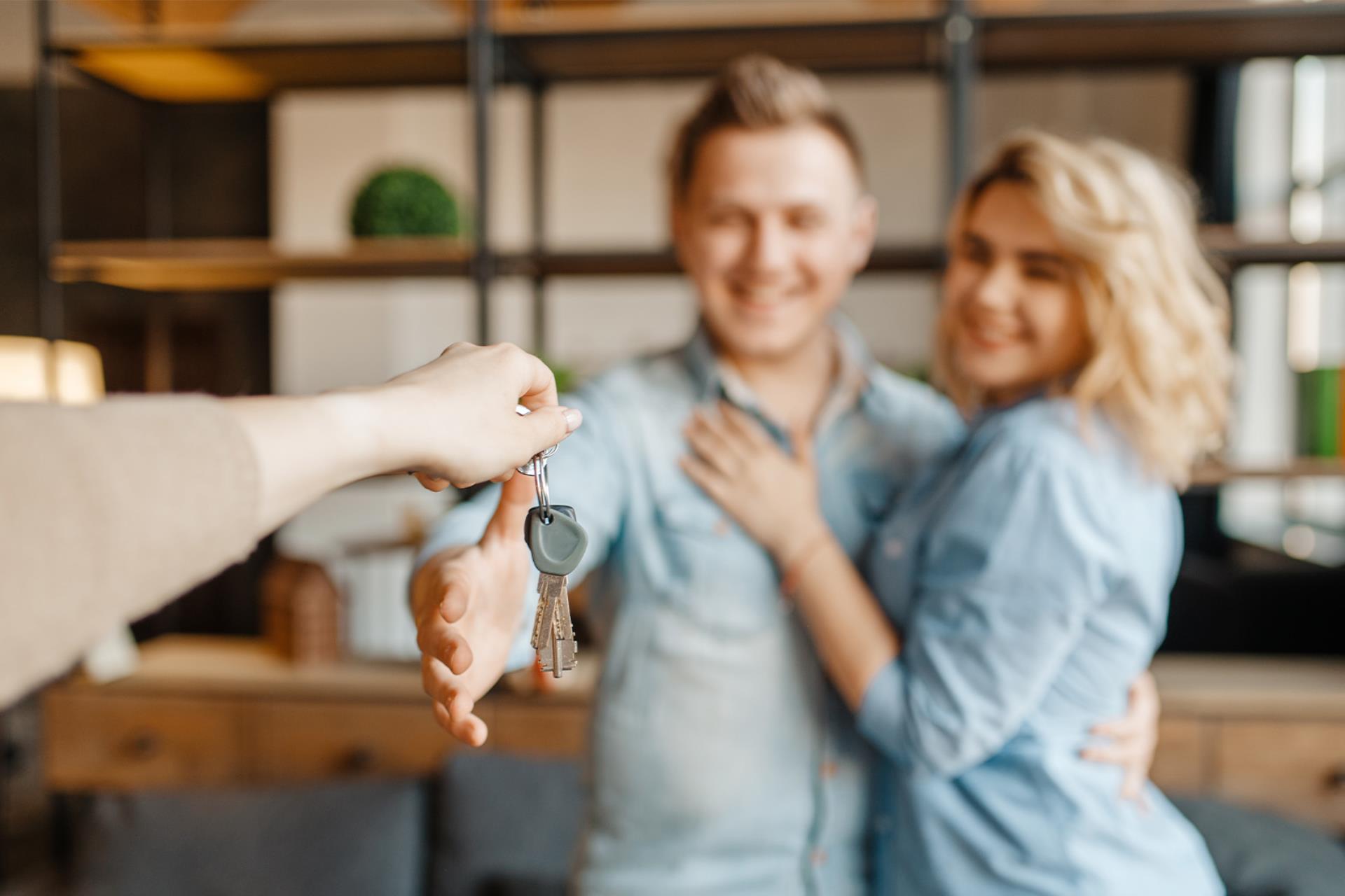 Young couple getting their new home keys