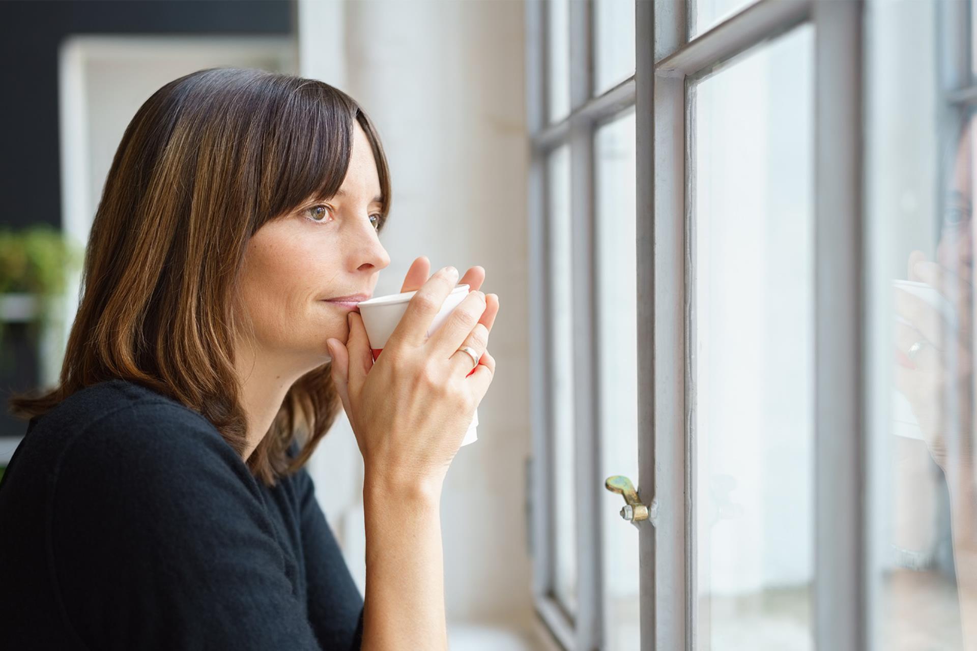 Contemplative lady drinking coffee